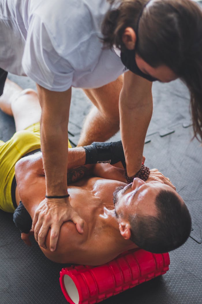 services-03 Athlete receiving therapeutic massage using foam roller for muscle relaxation and recovery
